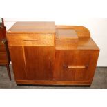 An Art Deco oak sideboard, fitted with a top lifting cutlery compartment, drawers and cupboards