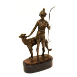 A bronze figure group depicting Diana The Huntress with a dog on oval black marble base, 13cm high