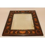 An Arts & Crafts copper mounted wall mirror, having heart and floral embossed decorations, 64.5cm