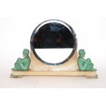 An Art Deco circular bevelled wall mirror on alabaster base, flanked by painted metal seated semi