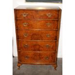 A 20th Century walnut and cross banded bow fronted chest, fitted five long drawers raised on