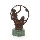 After G Omerth, bronze study of a naked girl with floral hoop raised on a green marble plinth,