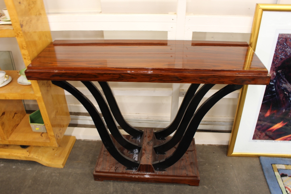 An Art Deco style console table, raised on bowed ebonised reports 120cm wide