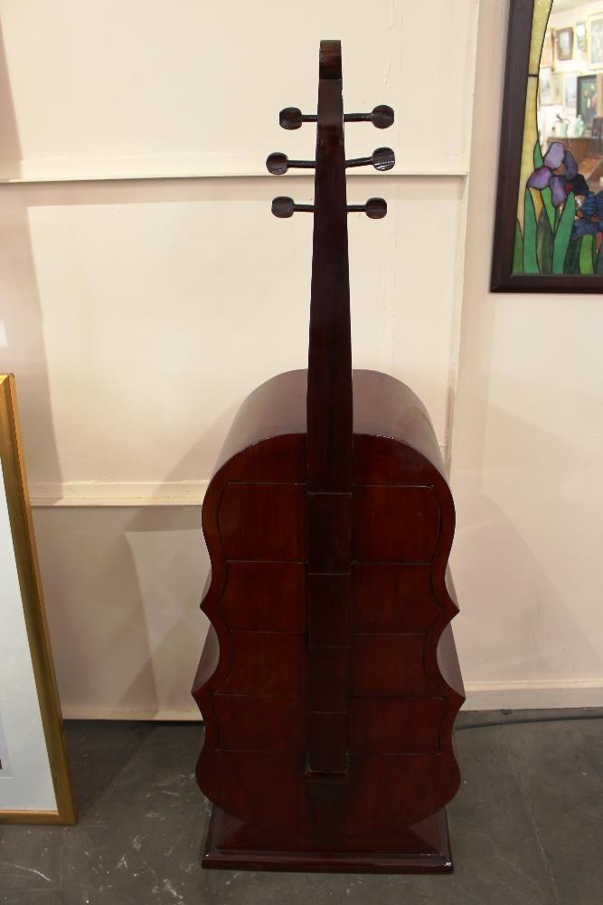 An unusual four drawer chest, in the form of an upright cello, 160cm high x 53cm wide in extremes