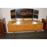 A 1970's blonde dressing table with triple mirror back, 152cm wide