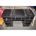 A leather suitcase shaped kneehole desk, 110cm wide