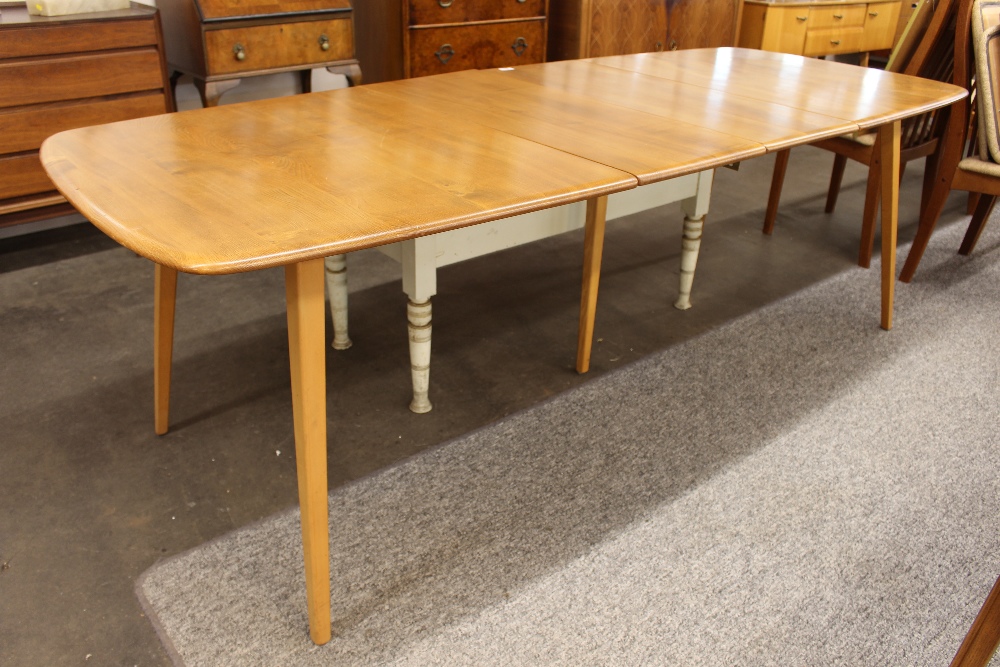 A blonde Ercol extending dining table, 244cm long