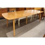 A blonde Ercol extending dining table, 244cm long