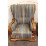 An oak Danish armchair, having foliate carved decoration upholstered in striped tapestry