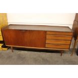 A G-plan design teak sideboard, fitted double cupboards flanked by four long drawers raised on