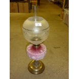 A Victorian brass oil lamp with coloured glass res