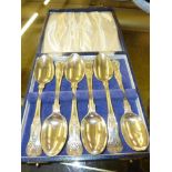 A box containing six silver teaspoons and one othe