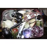 A tin containing a glass paperweight; onyx eggs; e