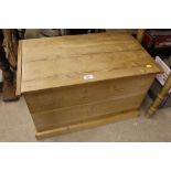 A stripped pine storage box