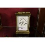 A brass cased carriage clock with key