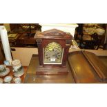 A 1920's oak two hole mantel clock with presentati