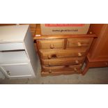 A small stripped pine chest fitted two short over