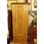 A stripped pine single door wardrobe fitted single