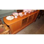 A modern beech effect glazed sideboard fitted four