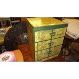 A three drawer bedside chest decorated with maps