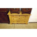 A stripped pine three drawer chest`