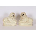 A pair of Staffordshire recumbent lion ornaments, 28cm long x 26cm high