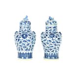 A pair of Chinese blue and white baluster vases, the lids surmounted by kylin finials, 39cm high