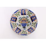 A pair of Delft style plates, with brightly coloured decoration of flowers, 23.5cm dia., (damaged)