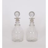 A pair of 19th Century ring neck mallet shaped decanters, having faceted stoppers, 23cm high