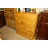 A light oak chest fitted two short over three long