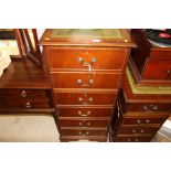 A reproduction mahogany filing cabinet