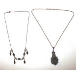 A silver and garnet set necklace; and one other ne