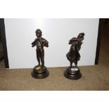 A pair of bronze statues in the form of musicians