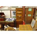 A reproduction yew wood and glazed corner cabinet