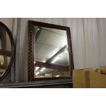 A mahogany framed and bevel edged wall mirror