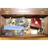 A wooden trinket box containing costume jewellery;