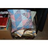 A box of textiles and cushions