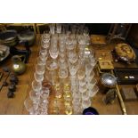 A quantity of various drinking glasses; a decanter