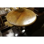 A mahogany circular top tripod table