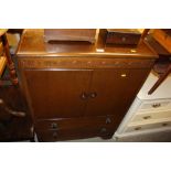 An oak veneered tallboy fitted two drawers below