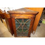 A mahogany and glazed hanging corner cabinet