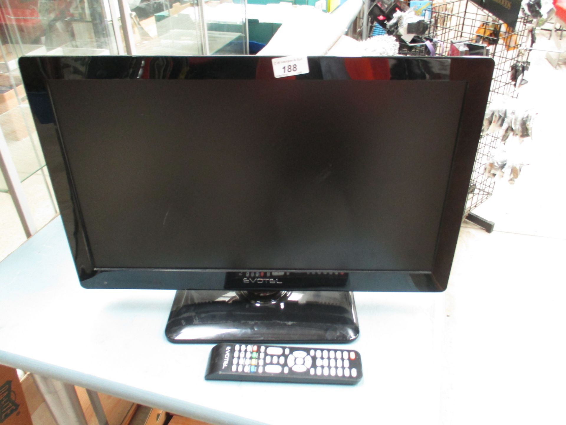 A Evotel ELED22L5DVD 22" LCD TV complete with power adaptor and remote control (scratch to screen)