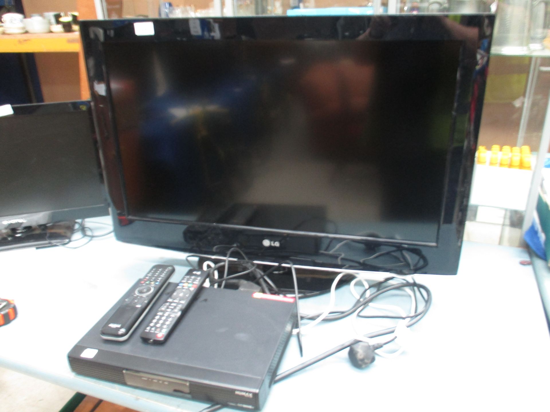 An LG 32" 32LD 420 flat screen TV complete with remote control and a Humax PVR-9150T freeview box