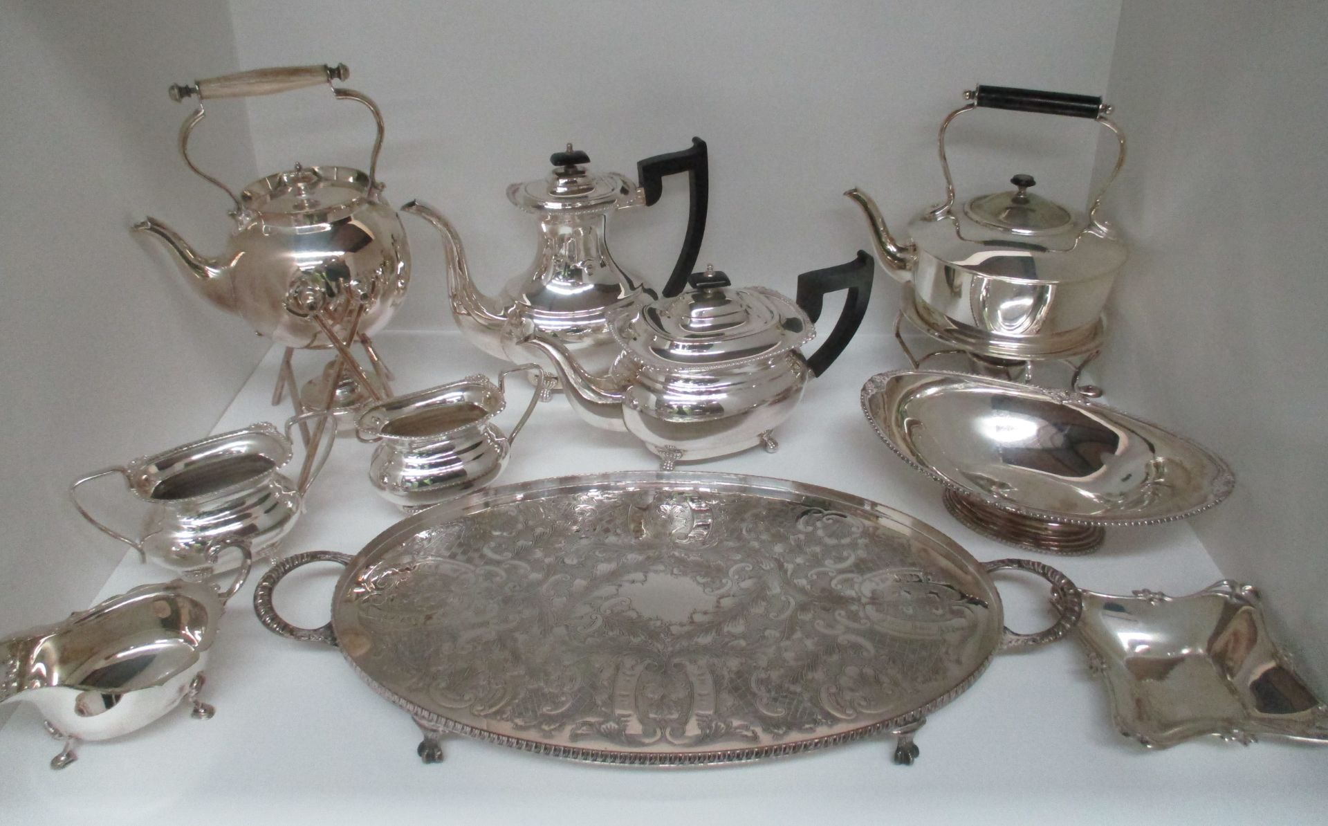 A four piece electroplated tea service of oval baluster shape, two spirit kettles, etc.