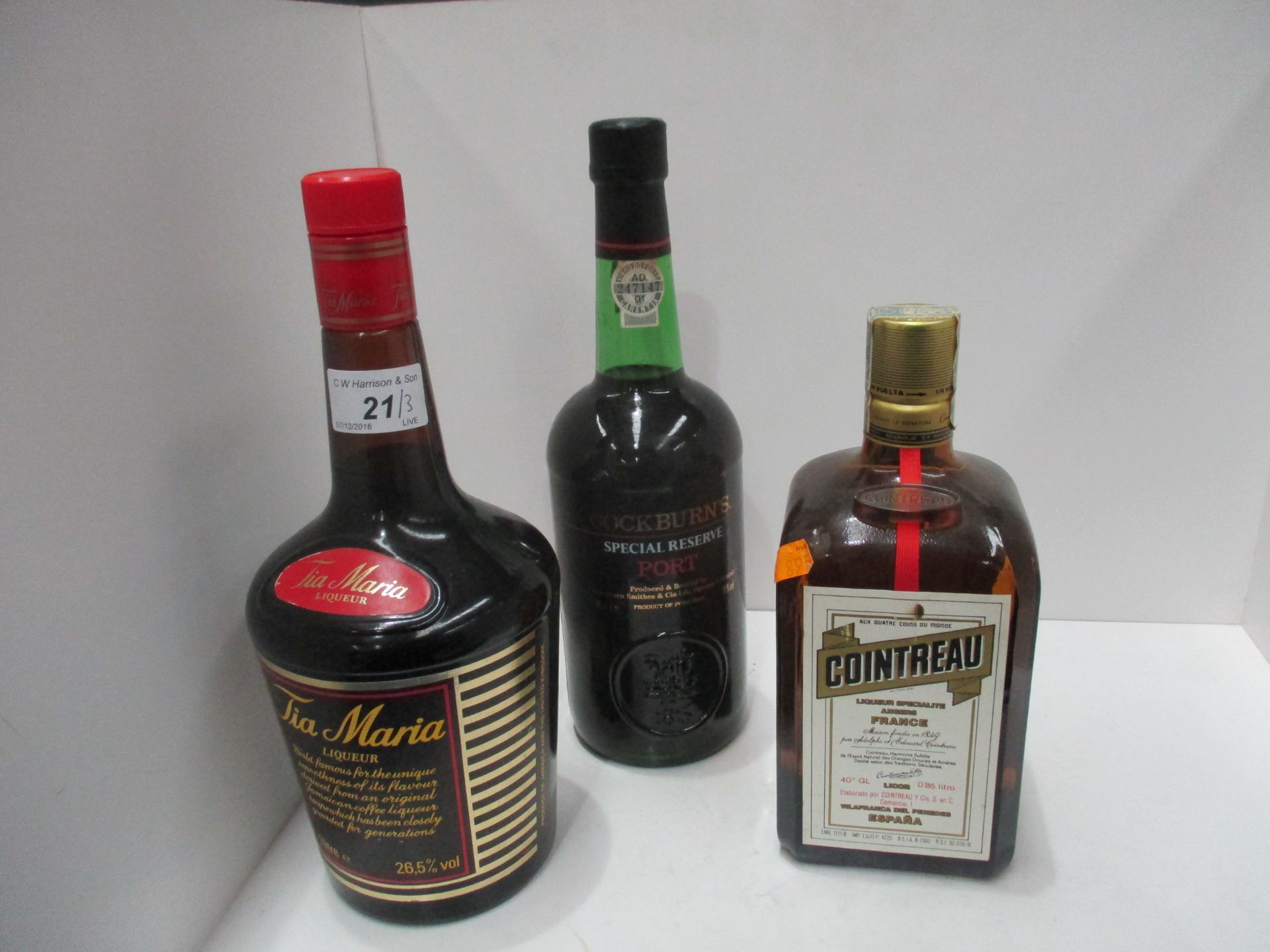 A 1 litre bottle of Tia Maria liqueur, an 85cl bottle of Cointreau and a 70cl bottle of Cockburns