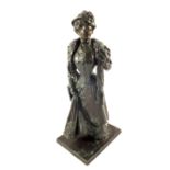 A Bronze of a standing Victorian woman, signed P.