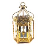 A large decorative 19th Century glazed Brass hall lantern of hexagonal shape with scrolled arms