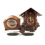 A Black Forest Cuckoo clock with a mantel clock