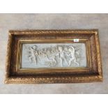 A gilt framed relief plaque of cherubs and flowers,