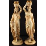 A pair of Royal Worcester blush ivory figures of ladies with Grecian urns, height 20",